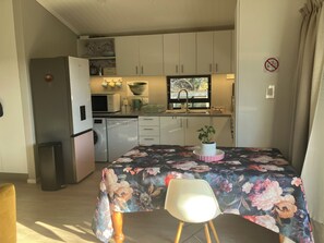 A compact kitchen with a microwave, sink, and a potted plant on the counter. - Superb 2-bedroom cottage in charming Stellenbosch for your getaway (Stellenbosch)