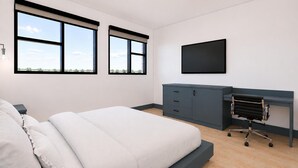 Quarto moderno com cama, escrivaninha e cadeira. Há duas janelas e uma televisão de tela plana na parede.