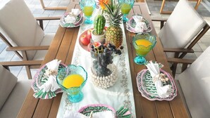 A dining table set with glassware, fruits, and decorative items. - Tampa High Roller, Relax and Play (Tampa)