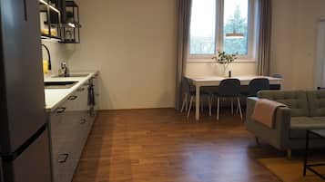 A compact living space with a kitchenette, dining area, and seating area.
