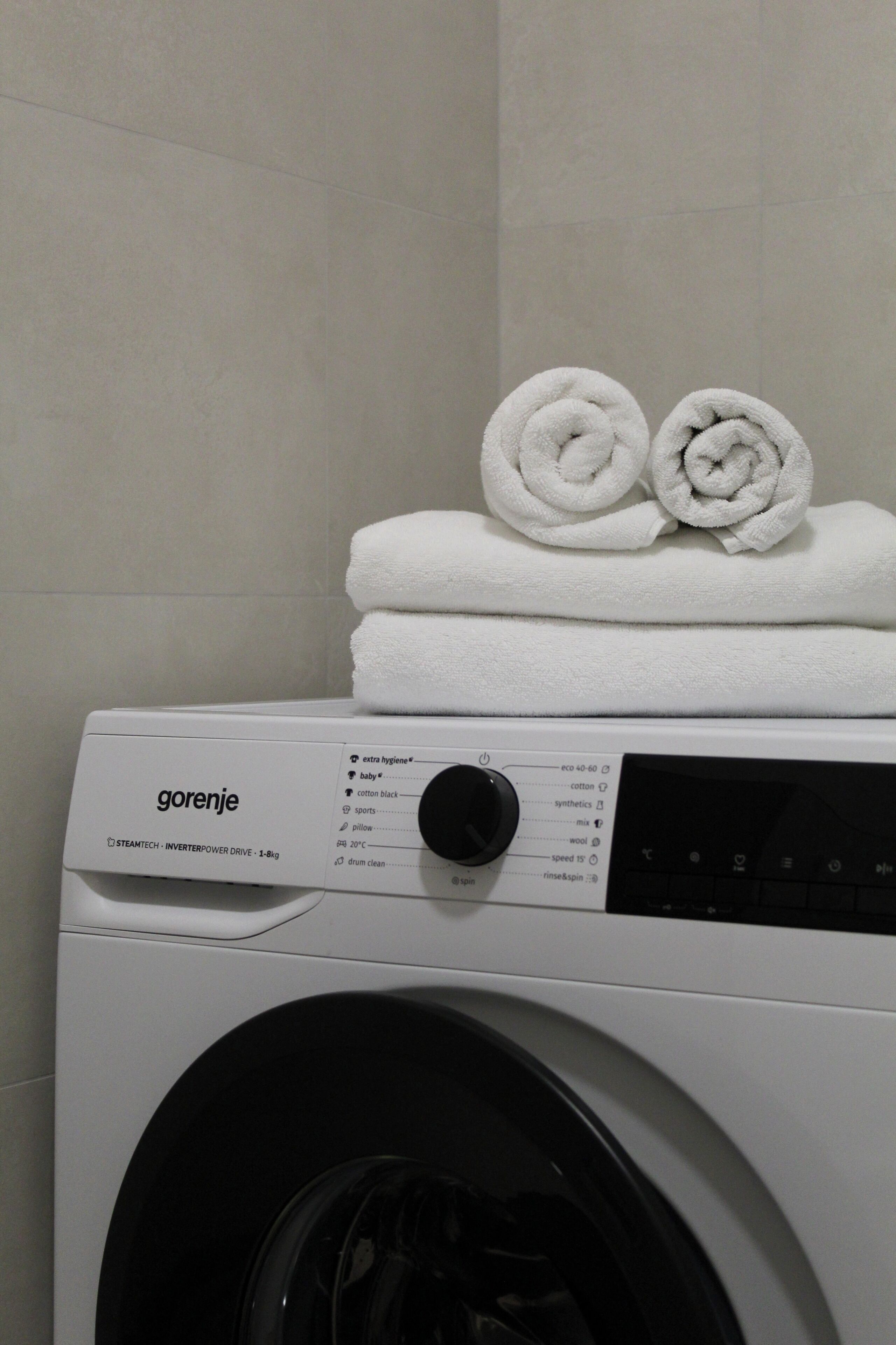 A white washing machine with a control panel and a label that reads 'gorenje.'