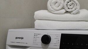 A white washing machine with a control panel and a label that reads 'gorenje.'
