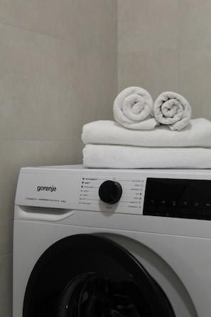 A white washing machine with a control panel and a label that reads 'gorenje.'