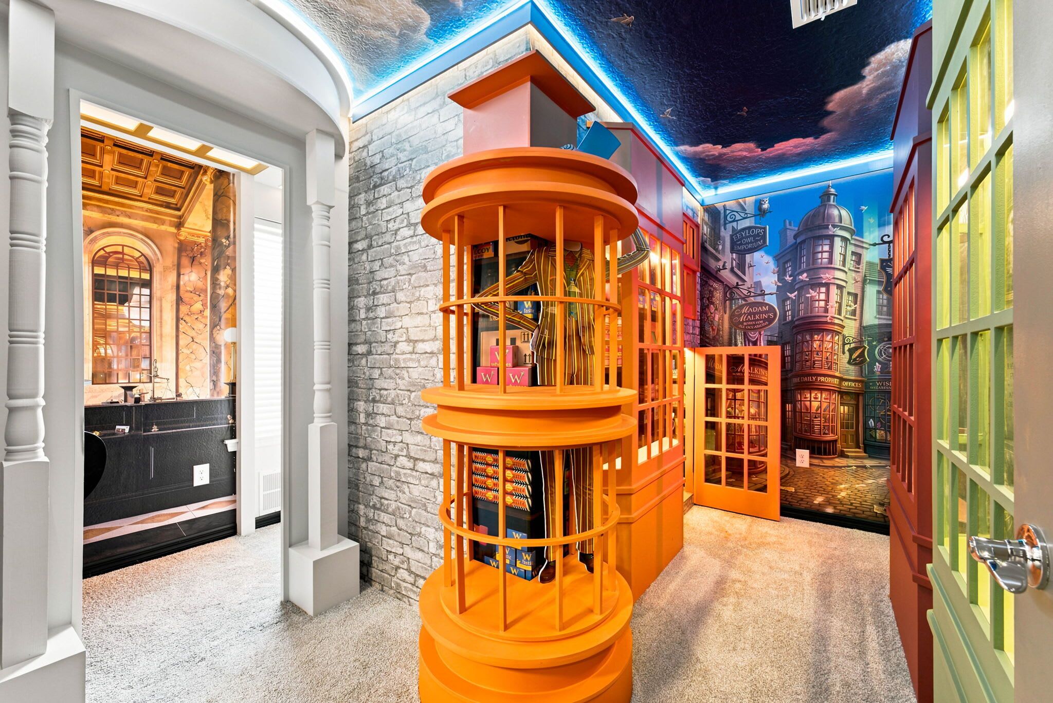 A room with a brick wall, a white column, and a colorful mural of a cityscape.