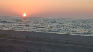 A sunset over a body of water with a road in the foreground. - Eligio Luxury Residence with Private Jacuzzi & Sea View (Gournes Gouvon)