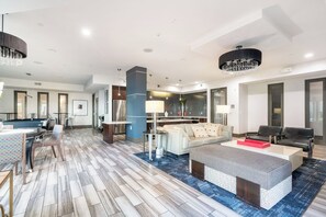 A modern living room with a pool table, a sofa, a coffee table, and a chandelier. - Executive 1BR Houston Balcony, Fast Wi-Fi and In-Unit Laundry (Houston)