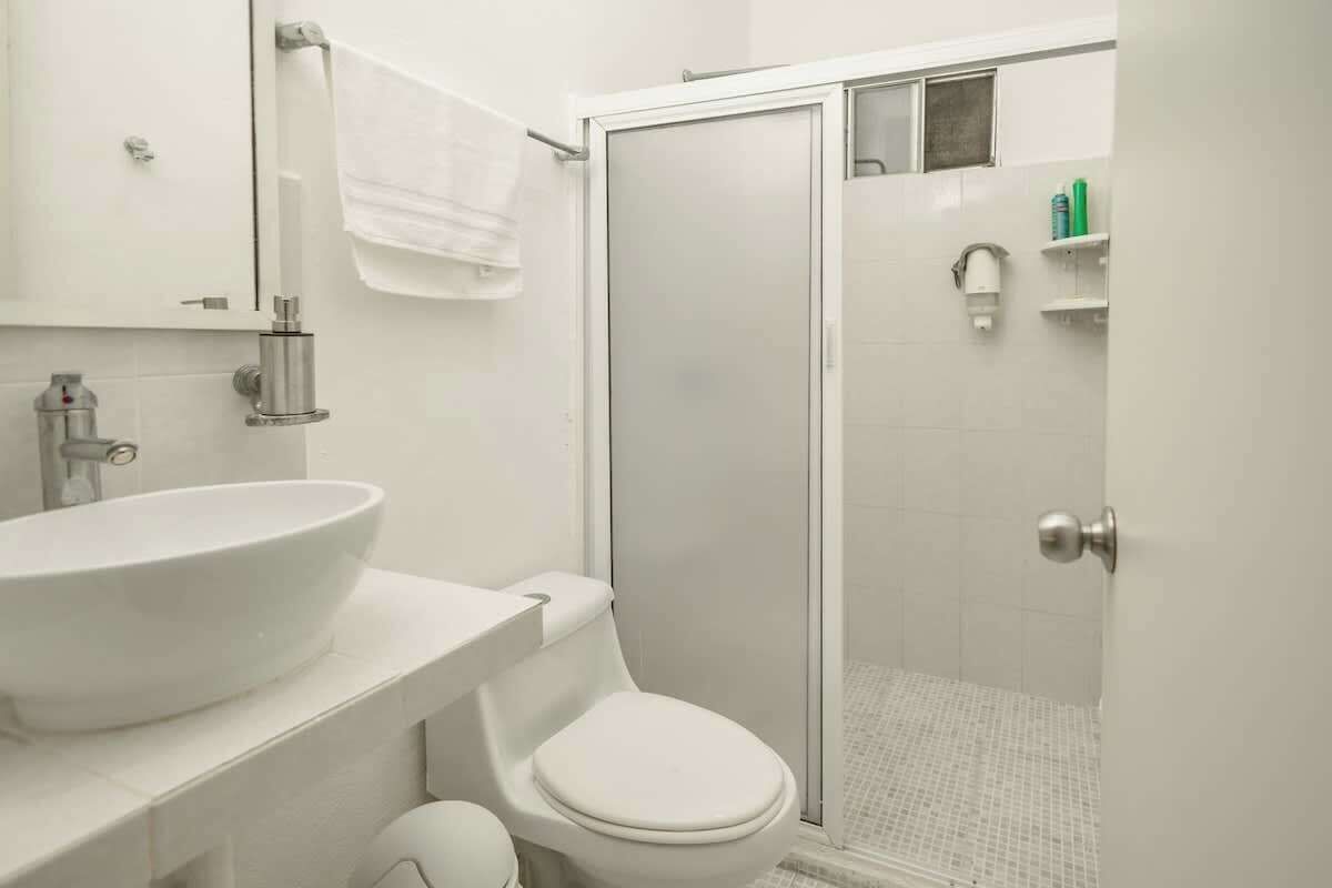 Shower, hair dryer, towels, shampoo