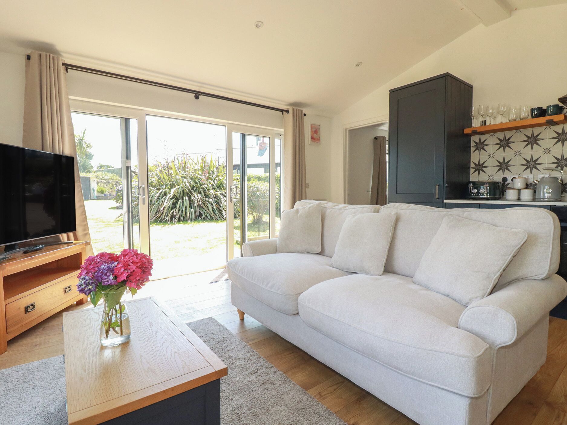 A modern living room with a sofa, a TV, and a coffee table.