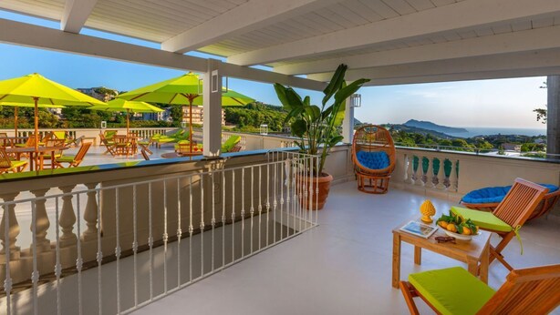 A terrace with outdoor seating, umbrellas, and a view of the landscape. - Luxury Authentic Italian Villa with Private Pool & Iconic Seaview Terrace (Massa Lubrense)