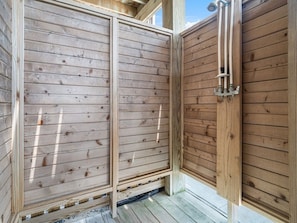 A wooden fence with a metal gate, a wooden deck, and a clear sky. - Seabatical-4x4, Semi-Oceanfront w/ Pool & Hot Tub (Carolla)