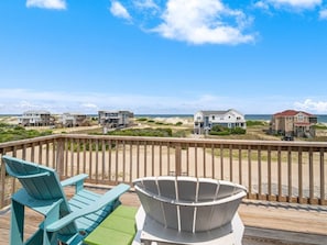 A wooden deck with a view of beach houses and the ocean. - Seabatical-4x4, Semi-Oceanfront w/ Pool & Hot Tub (Carolla)