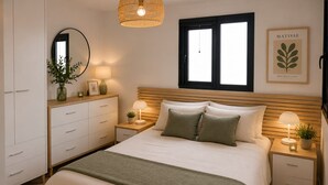 Una camera da letto con un letto, comodini, una cassettiera, uno specchio, una finestra e un'opera d'arte appesa al muro.