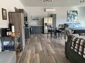 A compact living space with a kitchenette, dining area, and a bed. - HIDE-A-WAY SUITE RETREAT … Just Steps Away From shoreline on Bitterroot Lake (Marion)