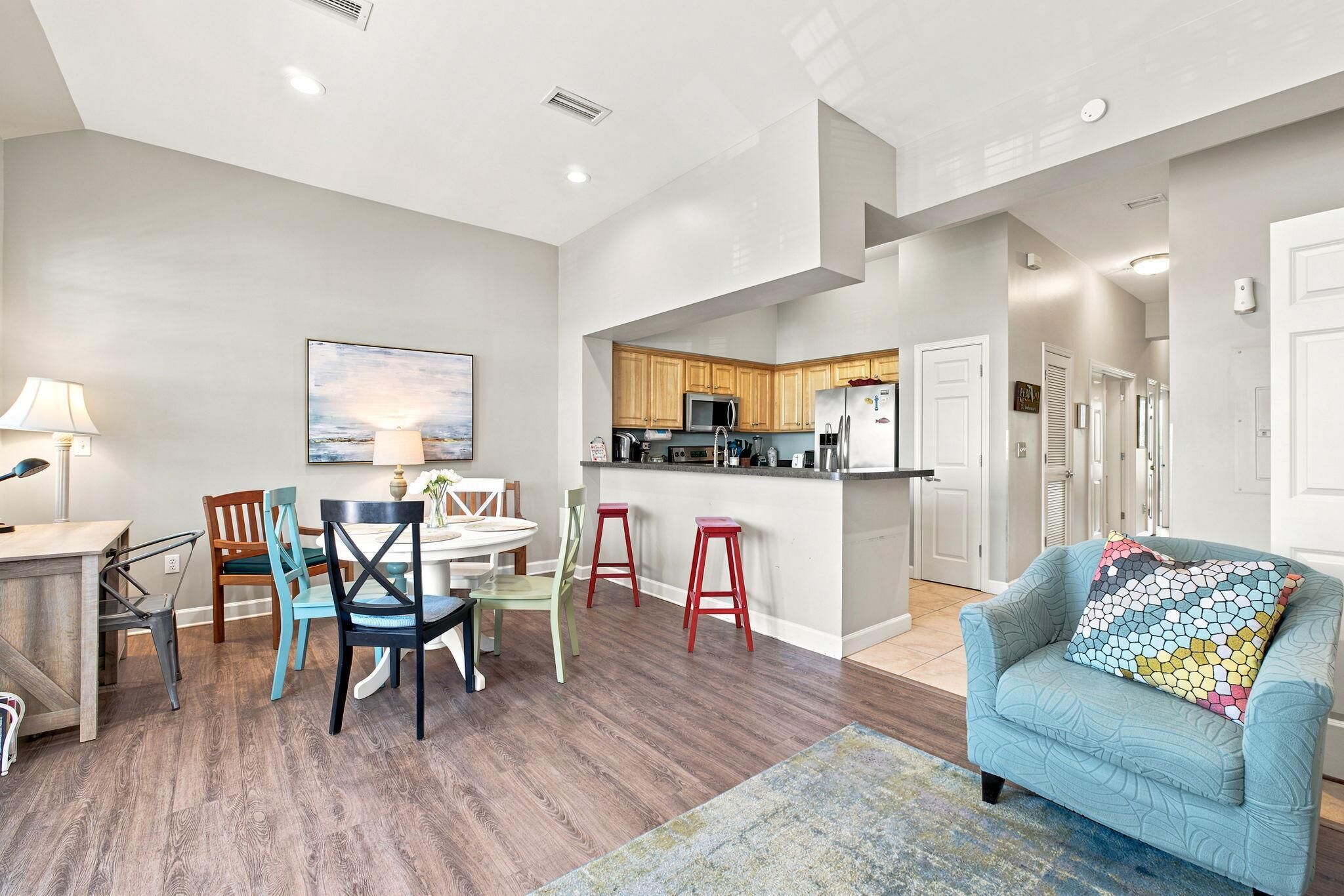 A modern apartment with a dining area, kitchen, and living room.