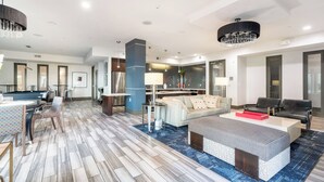 A spacious living area with a pool table, a sofa, and a coffee table. - Downtown Houston 1BR • Balcony • Fast Wi-Fi • Free In-Unit Laundry (Houston)