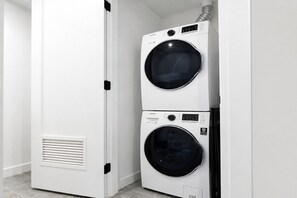 A white wall with a built-in washer and dryer unit. - Comfy Condo-Hotel in Downtown Miami (Miami)