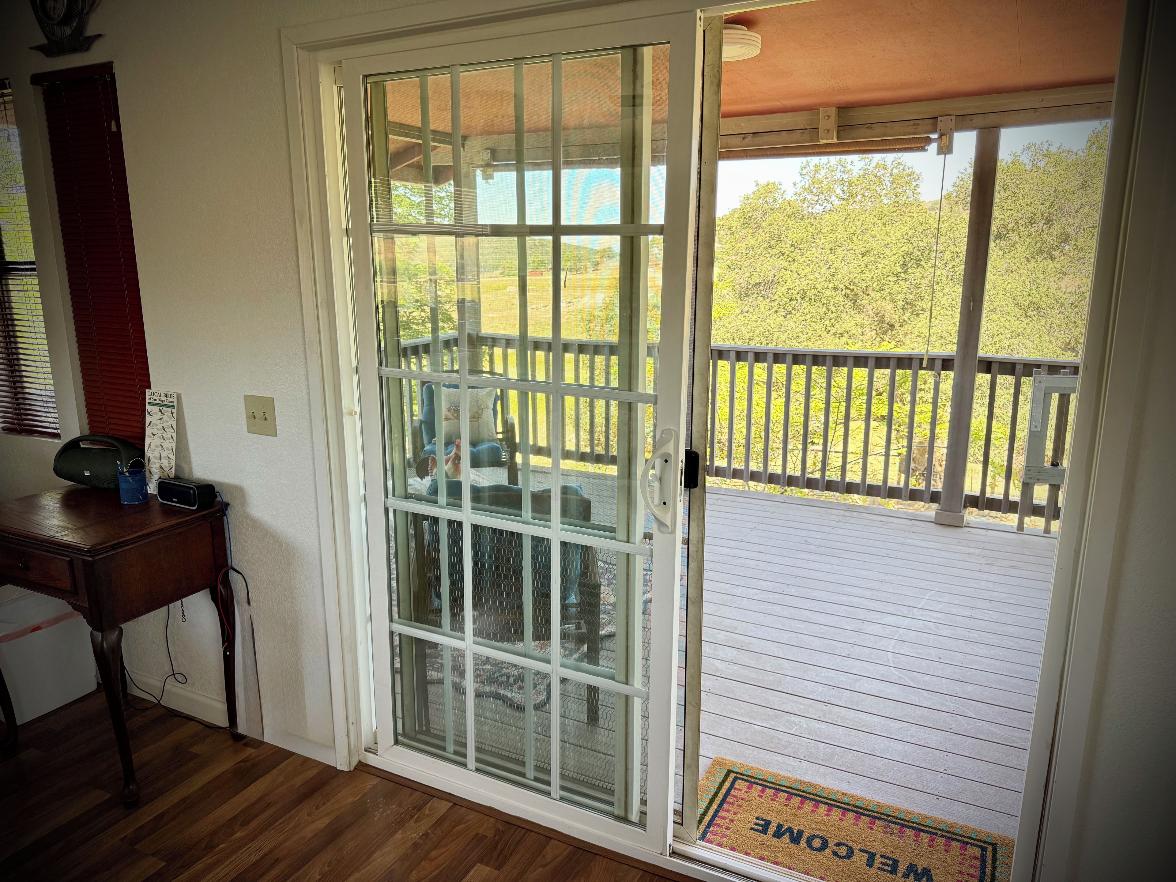 A room with a sliding glass door leading to an outdoor deck.