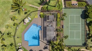 An aerial view of a property with a swimming pool, tennis court, and surrounding greenery. - Wailea Ekahi 42C - Peekaboo Ocean Views, 2 Full Baths, King Tempurpedic, Full AC (Kihei)