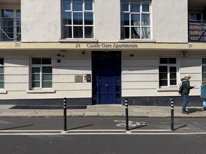 A building with a blue door and the sign 'Castle Gate Apartments' above it. - Apartment 54, Castle Gate is a spacious top-floor apartment in the heart of Dub (Dublin)