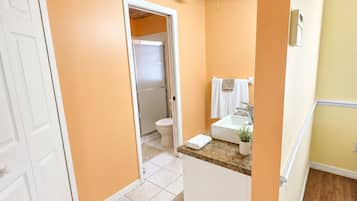 Suite, Pool View | Bathroom | Combined shower/bathtub, free toiletries, towels, soap