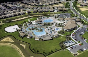 An aerial view of a resort with multiple swimming pools, a golf course, and a parking area. - The Power-Up Palace, 9 beds, private pool (Four Corners)