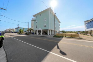 A two-story building with a flat roof and a balcony on the second floor. - Luxury Oceanfront Carolina Beach Condo w/ Private Beach Access. Full ocean view! (Carolina Beach)