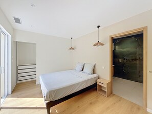 Ein Schlafzimmer mit Bett, Nachttisch und Kleiderschrank.