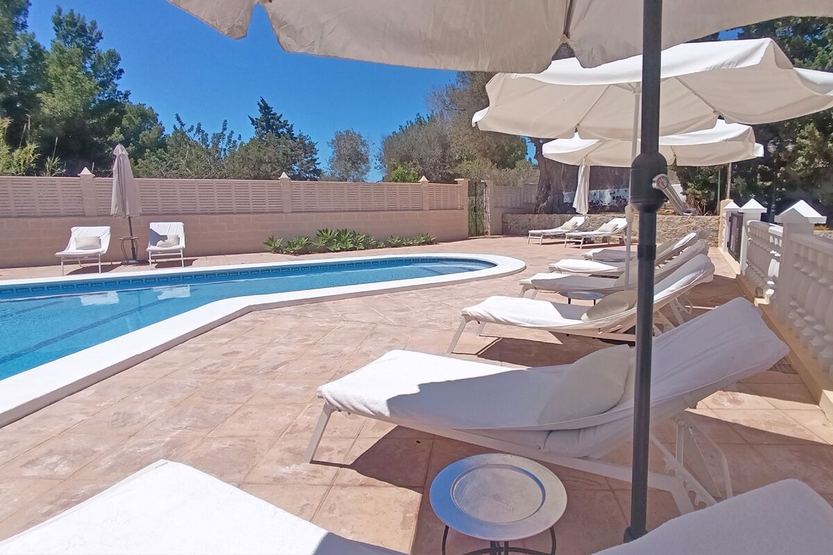 A poolside area with lounge chairs and umbrellas.