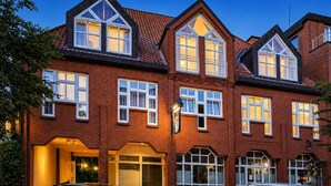 A multi-story brick building with multiple windows and a car parked in front. - 2 Person Holiday Park Home in Stade (Stade)