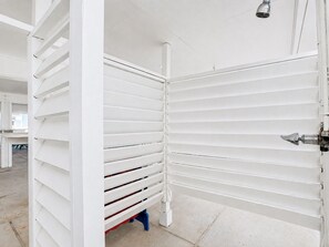 A room with white walls and a ceiling-mounted shower head. - Beachfront, Hot Tub, Arcade, Foosball, Steps to beach, outdoor games & MORE (Galveston)