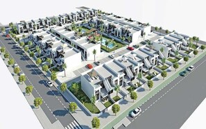 Un complejo residencial moderno con varios edificios, un patio central y una piscina.