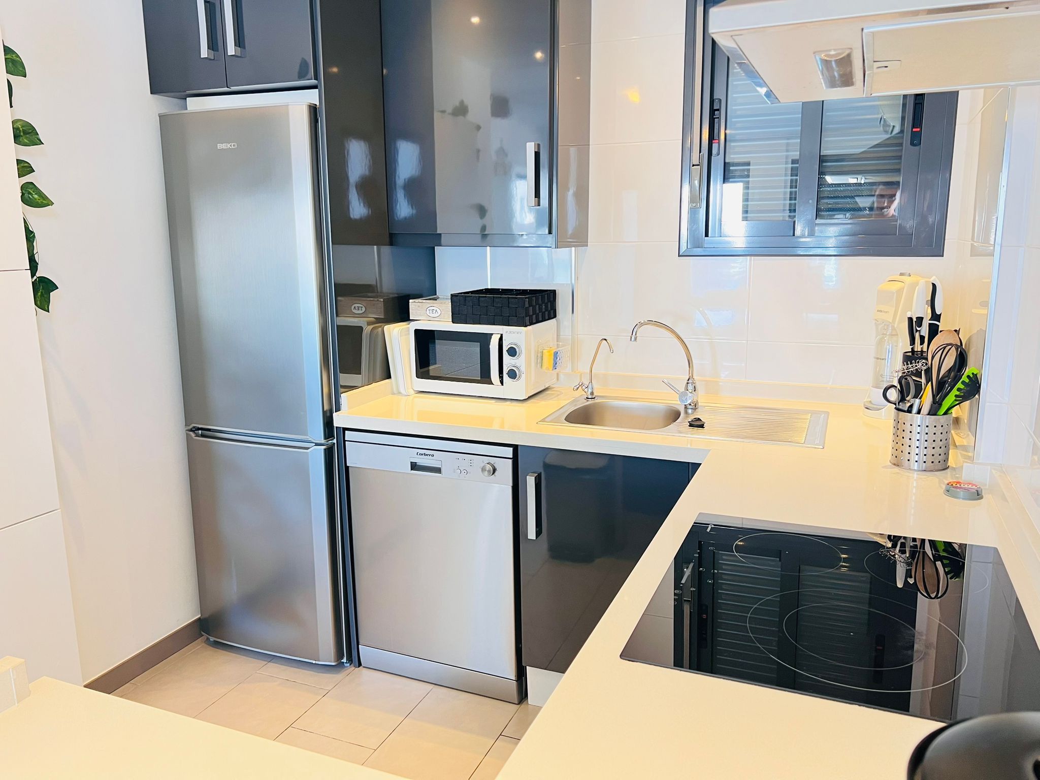 A modern kitchen with stainless steel appliances, a microwave, and a dishwasher.