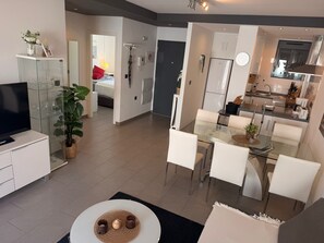 A modern apartment with a living room, dining area, and kitchen. - Penthouse Oasis Beach IV La Zenia (Orihuela)