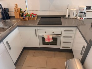 A modern kitchen with a built-in oven, a coffee maker, and a sink. - Penthouse Oasis Beach IV La Zenia (Orihuela)