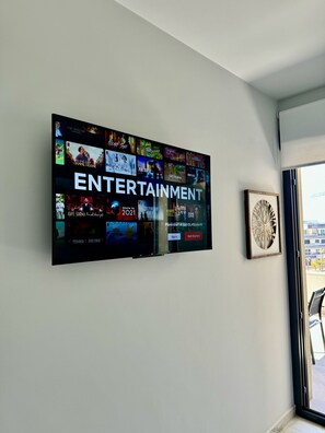A wall-mounted TV displaying various entertainment options. - Apartment Playa Flamenca Deluxe (Orihuela)