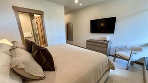 A bedroom with a bed, a chair, a television, and a dresser. - Clubhouse & Pool Amenities, 40 Mins to Glacier NP (Whitefish)