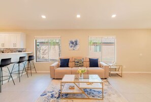A living room with a sofa, coffee table, and chairs. - Cozy Desert Escape with Modern ComfortsVilla (Casa Grande)