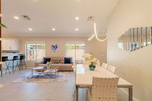 A modern living space with a dining area, kitchen, and seating arrangement. - Cozy Desert Escape with Modern ComfortsVilla (Casa Grande)