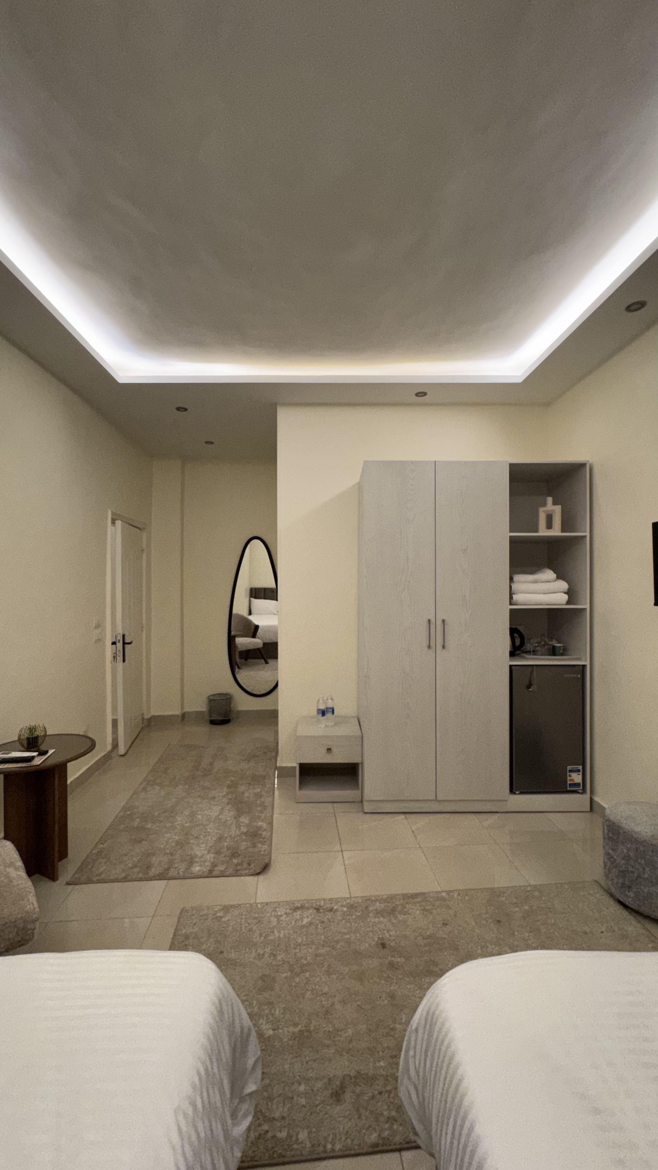 A modern bedroom with a skylight, a wardrobe, a bedside table, and a bed.