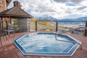 A hot tub on a wooden deck with a view of mountains and a town. - Irene`s Bike/HIke or Ski-In/Out! Hot Tub! Views! (Crested Butte)