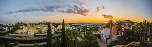 A residential area with modern buildings, a swimming pool, and a mountain in the background. - Sunrays Naturist Apartment in Playas de Vera (Vera)