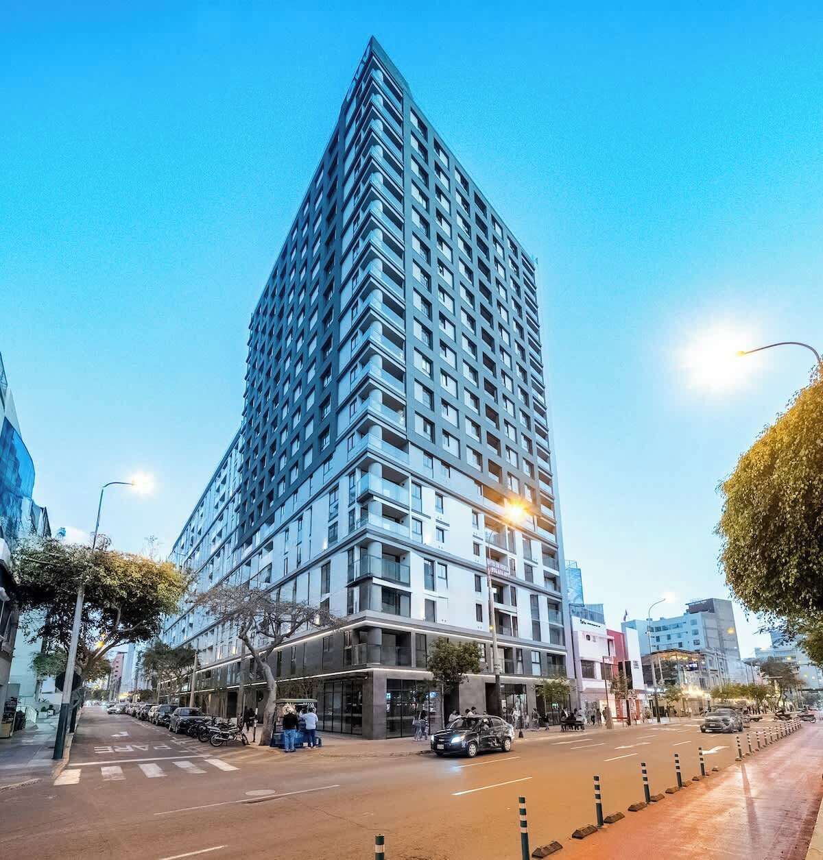 A high-rise building with multiple floors, a modern architectural design, and a clear sky.