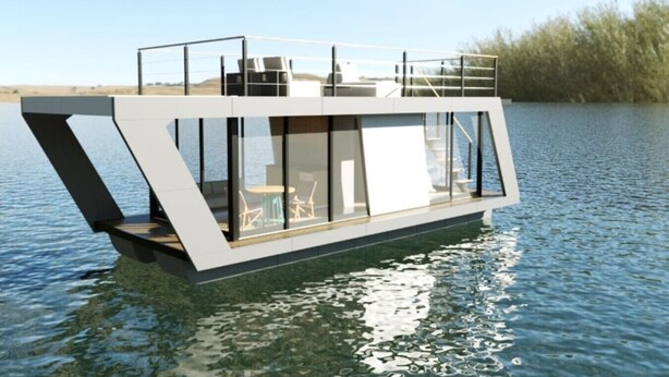 A modern floating houseboat with a deck, large windows, and a view of the water.