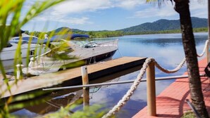A dock with boats, a clear sky, and a mountain in the background.