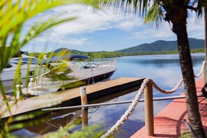A dock with boats, a clear sky, and a mountain in the background.