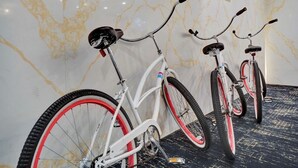 Three bicycles parked against a wall with a marble pattern. - Ocean View Large Condo in Beachfront Resort 1108 (Miami)