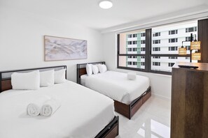 A hotel room with two beds, a large window, and a painting on the wall. - Ocean View Large Condo in Beachfront Resort 1108 (Miami)