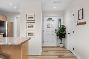A kitchen with a granite countertop, wooden cabinets, and a stainless steel refrigerator. - Sagewood: Two Kings, Fireplace and Pool (Branson)