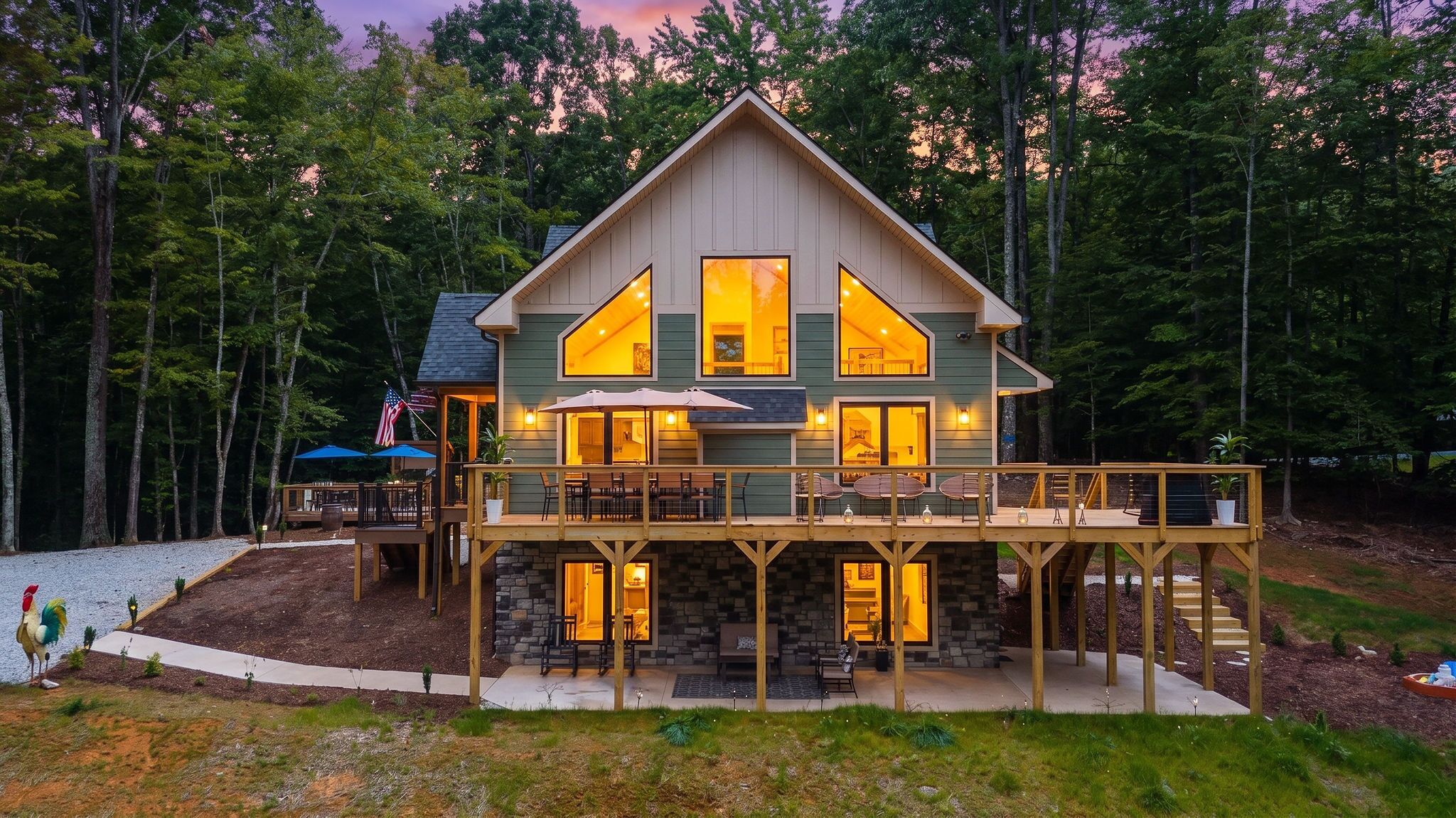A two-story cabin with a deck and outdoor seating area.