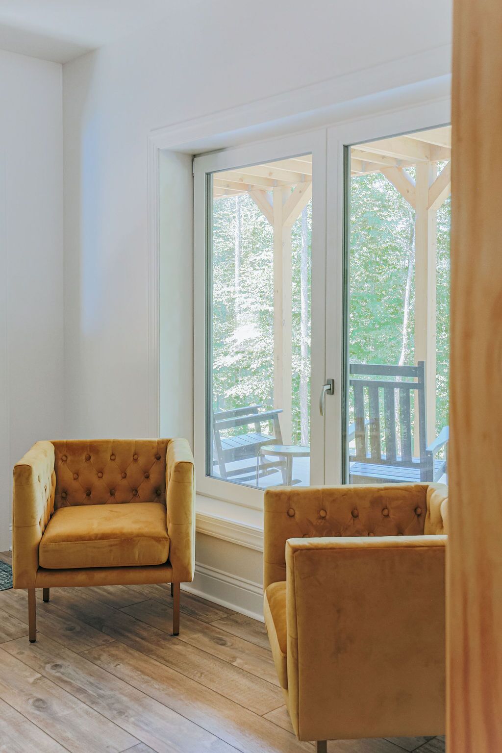 A room with a large sliding glass door leading to an outdoor deck.